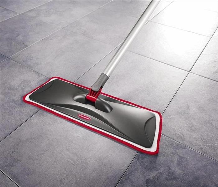 Mop cleaning a gray floor